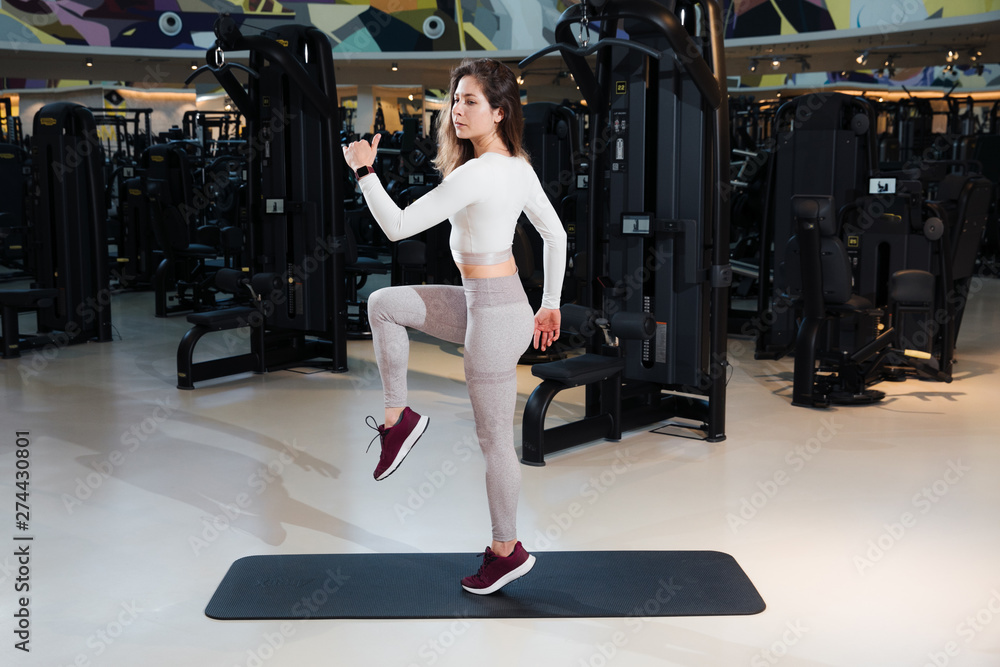 girl in sportswear is training in the gym