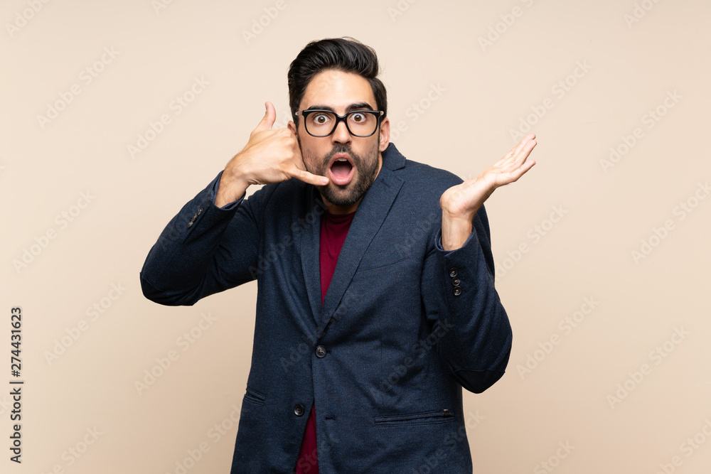Handsome young man over isolated background making phone gesture and doubting Handsome young man over isolated background making phone gesture and doubting