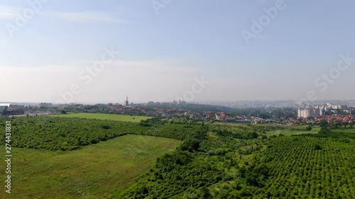 Slow moving aerial of Chisinau, Moldova. Moving across agricultural fields with the capital city on the hazy horizon. photo