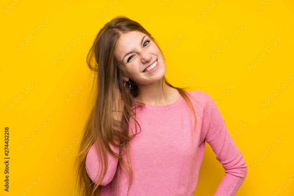 Young woman with long hair over isolated yellow wall having doubts Young woman with long hair over isolated yellow wall having doubts