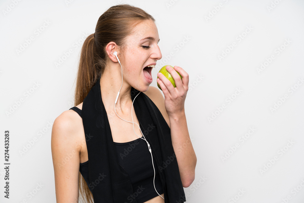 Young sport woman over isolated white background with an apple Young sport woman over isolated white background with an apple