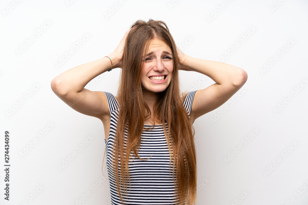 Young woman with long hair over isolated white wall frustrated and takes hands on head Young woman with long hair over isolated white wall frustrated and takes hands on head