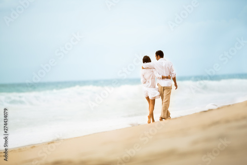 Love couple walking along beach
