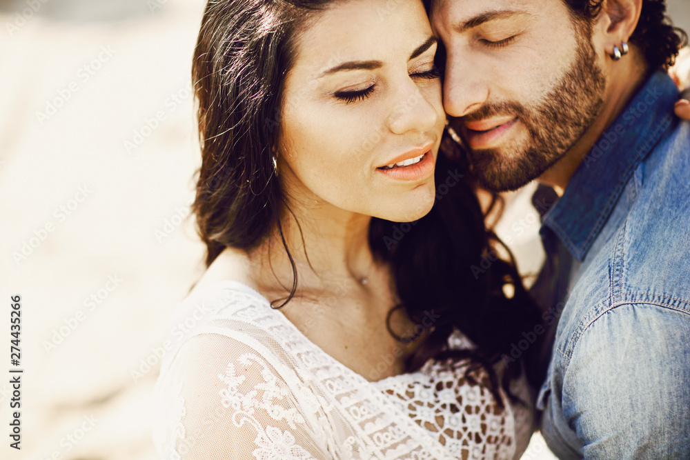 Close up portrait of a beautiful love couple at the beach. Love story. Italy, Rimini