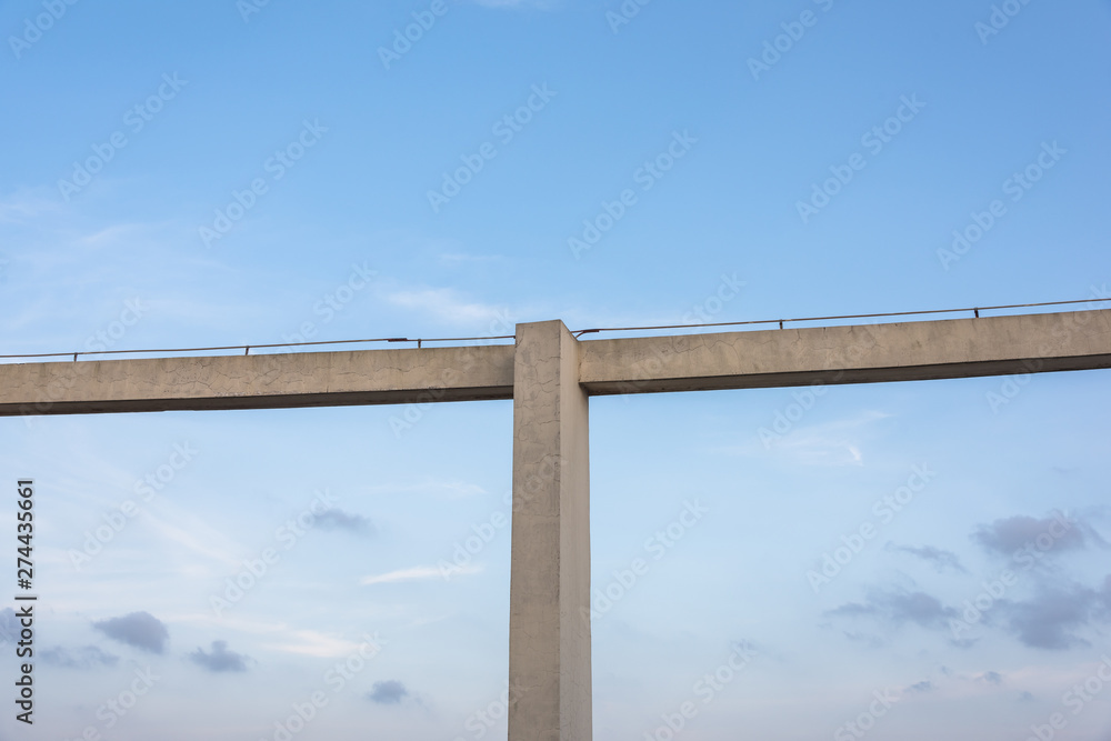 High-rise building top cross cement beams under blue sky background
