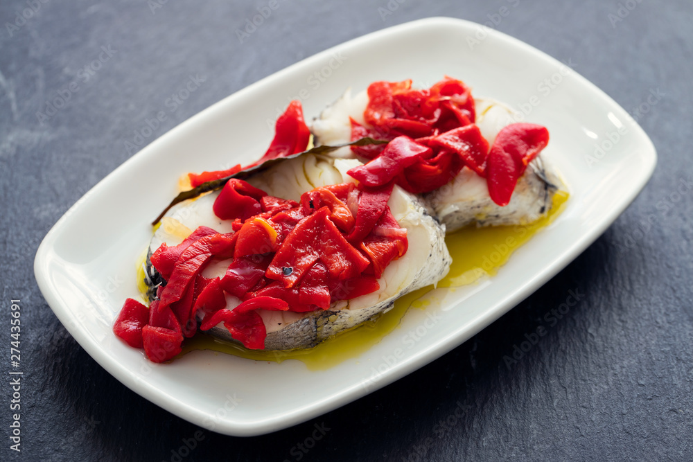 boiled fish with red pepper and olive oil on white dish boiled fish with red pepper and olive oil on white dish