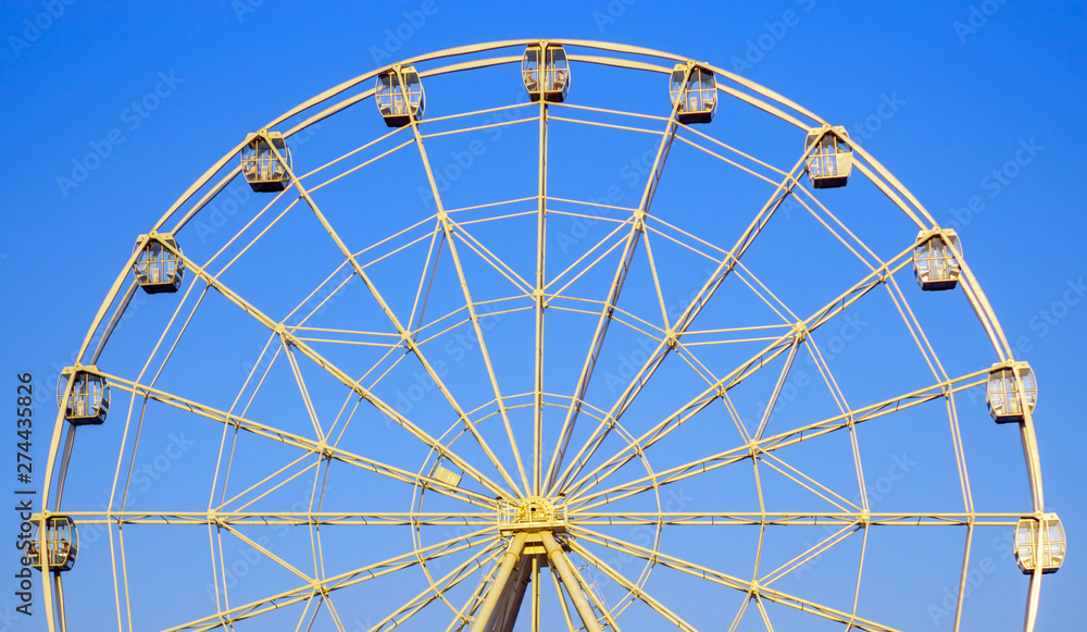 Ferris wheel in summer in the blue sky Ferris wheel in summer in the blue sky