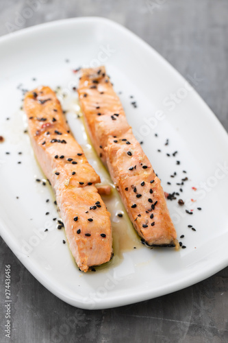 grilled salmon with black sesame on white dish
