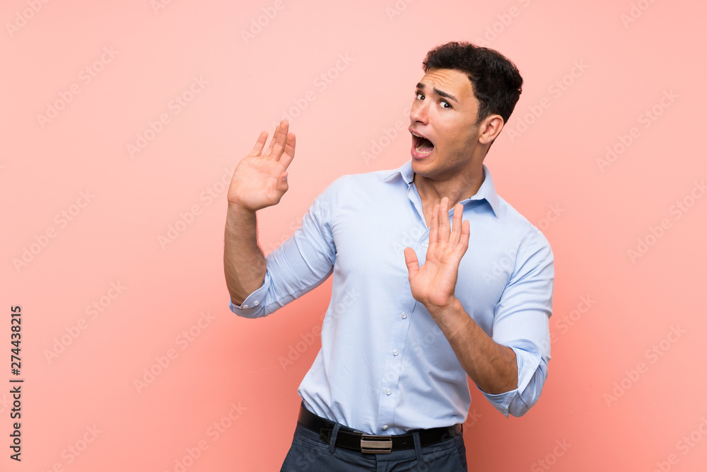 Handsome man over pink background nervous and scared Handsome man over pink background nervous and scared