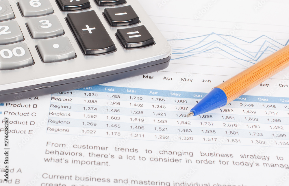 sheet of investment report with pen,and calculator sheet of investment report with pen,and calculator