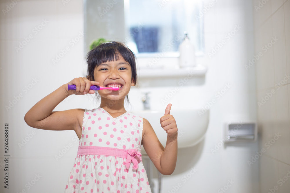 Little cute baby girl cleaning her teeth with toothbrush in the bathroom Little cute baby girl cleaning her teeth with toothbrush in the bathroom