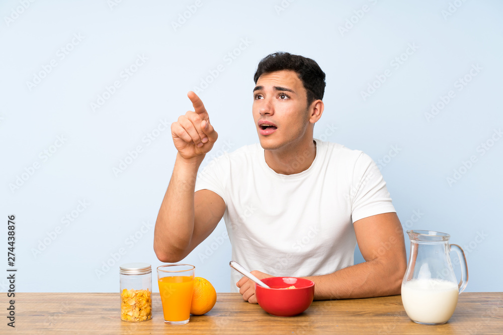 Handsome man in having breakfast touching on transparent screen Handsome man in having breakfast touching on transparent screen