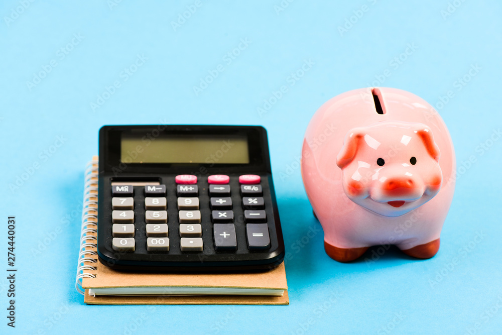 saving money. First salary. bookkeeping. financial report. family budget management. business start up. piggy bank with calculator. Moneybox. Poor life saving money. First salary. bookkeeping. financial report. family budget management. business start up. piggy bank with calculator. Moneybox. Poor life