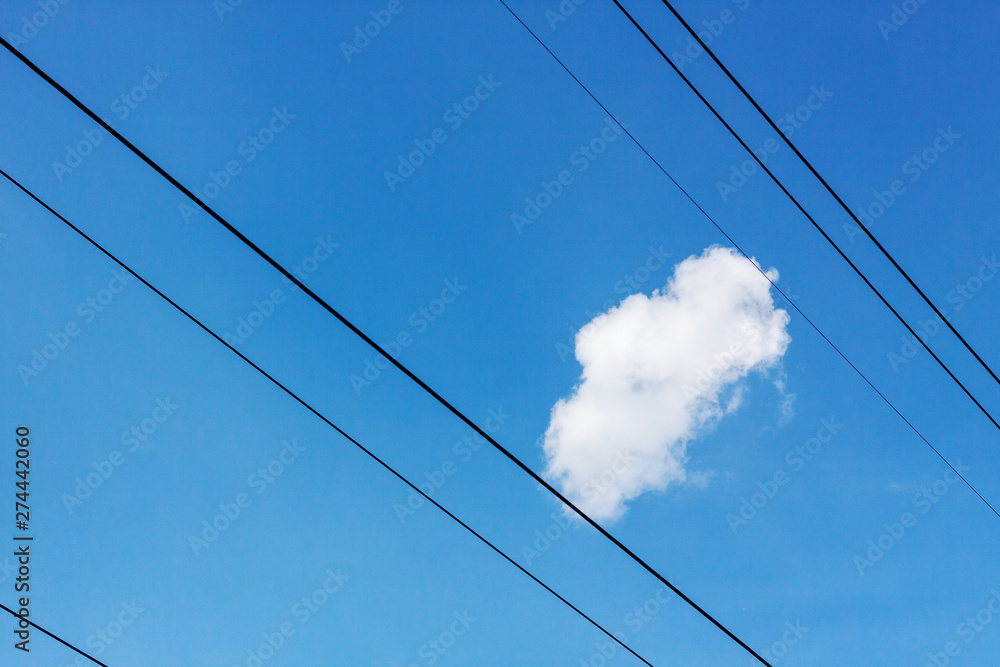 high voltage electricity line with blue sky and clouds behind it.