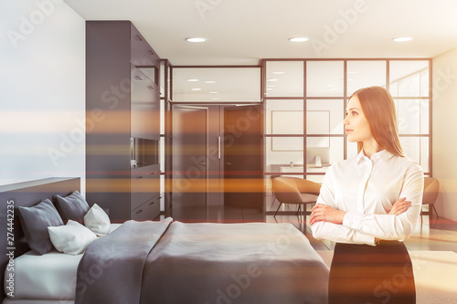 Woman in bedroom with home office