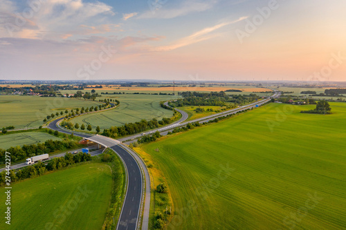 road and german highway or autobahn, agricultural fields and meadows