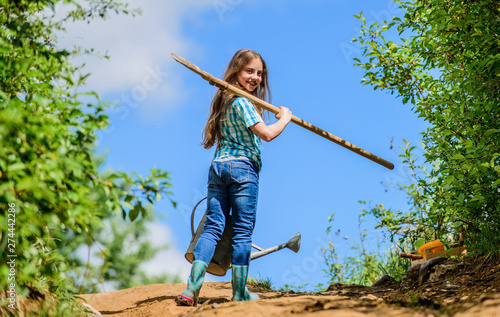 Girl child hold shovel watering can. Spring gardening checklist. Little helper. Watering tools that will solve dry yard problems. Gardening guide for beginners. Gardening tips. Spring gardening