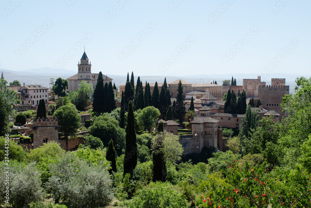 Fototapeta premium View of the Alhambra, opening from the alley in the gardens of Generalife, Granada, Andalusia, Spain