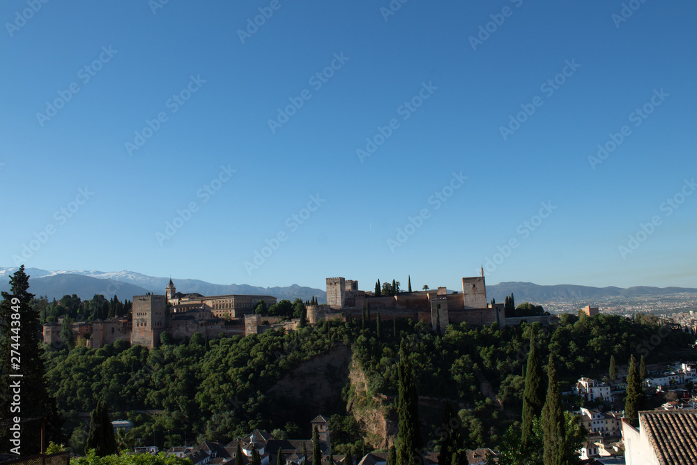 View of the Alhambra, opening from the alley in the gardens of Generalife, Granada, Andalusia, Spain