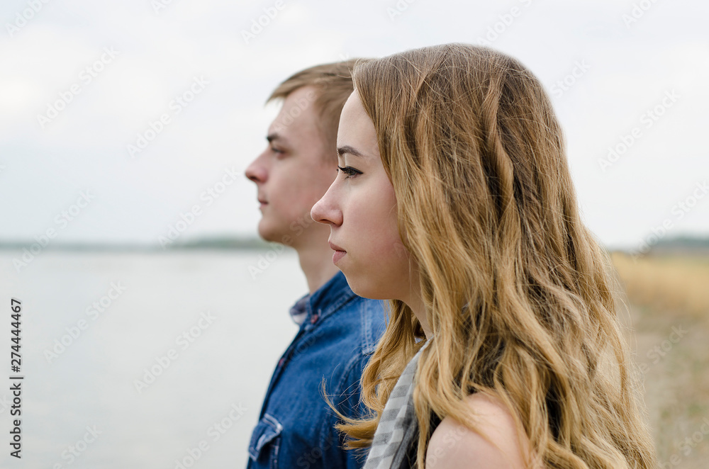 Faces of the girl and the guy close-up in profile.A young couple