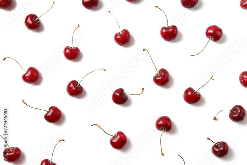 Ripe red cherries arranged on white background isolated