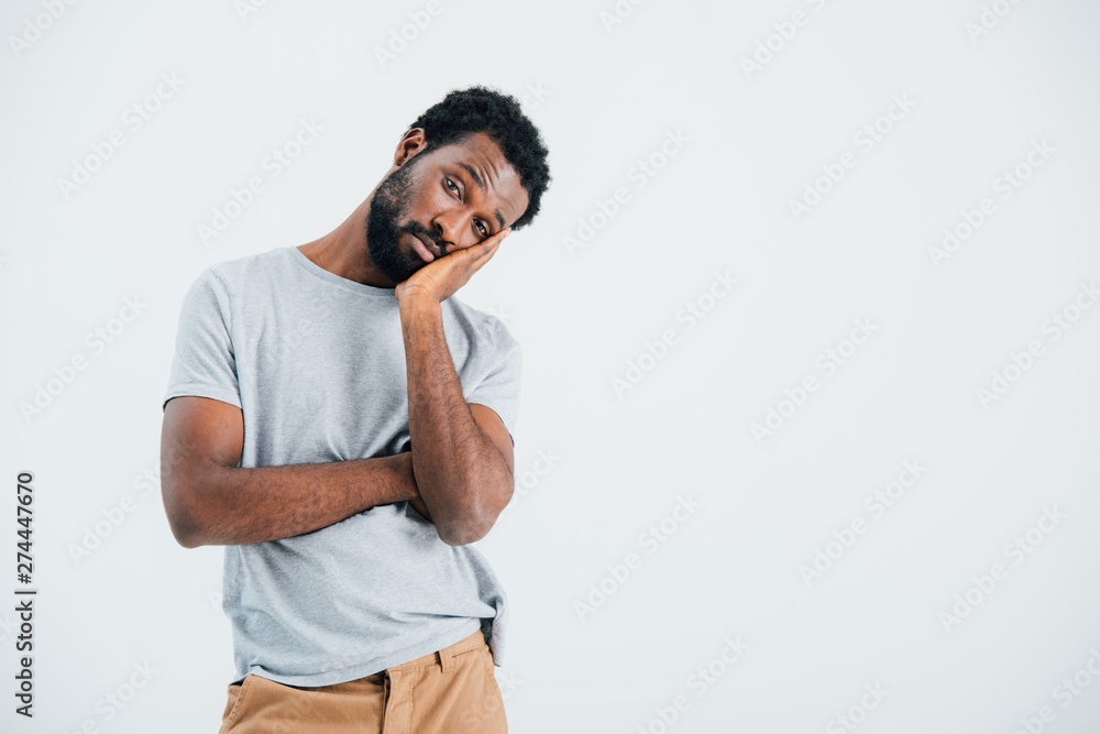 bored african american man in grey t-shirt, isolated on grey bored african american man in grey t-shirt, isolated on grey