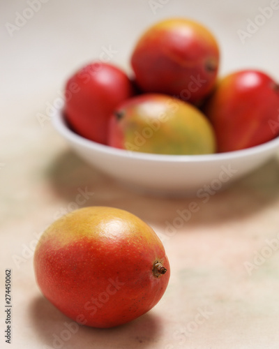 Delicious and healthy,  ripe mangos, ready to eat, in a bowl on a softly colored table cloth