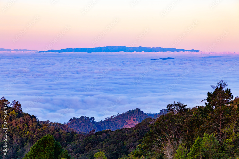 Mountains landscape with fog under morning sky.