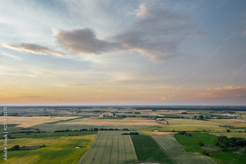 Agricultural field with the sunset sky, flatl ands of western Poland.