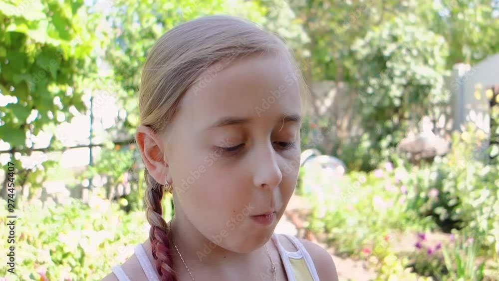 Little cute girl eating sweet apricot in the garden. Little cute girl eating sweet apricot in the garden.