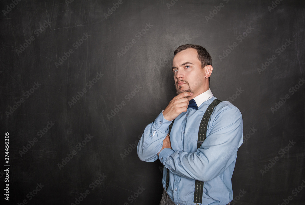 Thoughtful young business businessman or teacher looking up