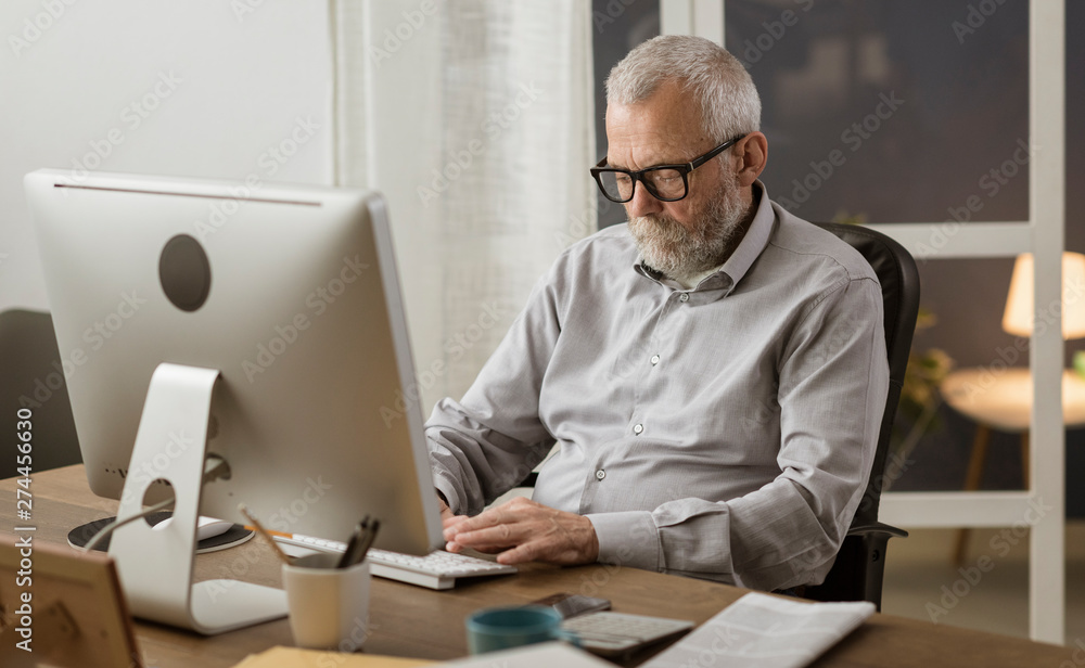 Senior man connecting with his computer at home Senior man connecting with his computer at home