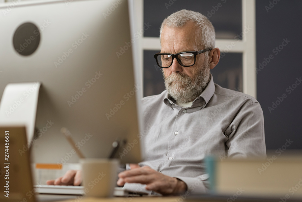 Senior man connecting with his computer at home Senior man connecting with his computer at home