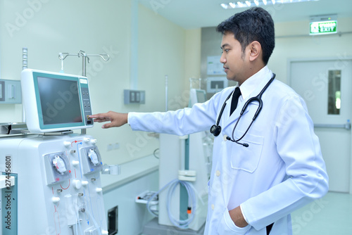 Doctor testing machine uses advanced dialysis equipment in the hospital.