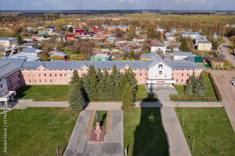 Suzdal from above. Red Squqre, Lenin monument, shadow of the monastery bell tower. Translate: Lenin, Administration of city Suzdal