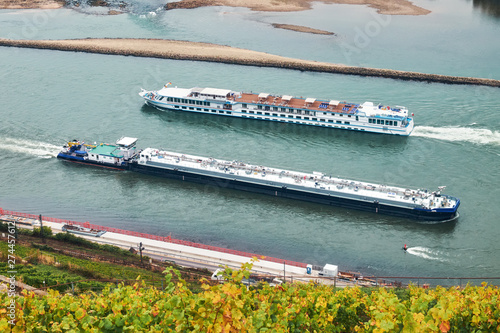 Fototapeta Long barge and motor ship swimming towards each other on the river Rhine in Germ