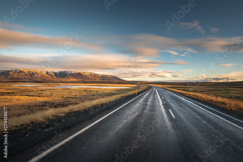 Landscape in Iceland waterfall sun mountains light golden hour road
