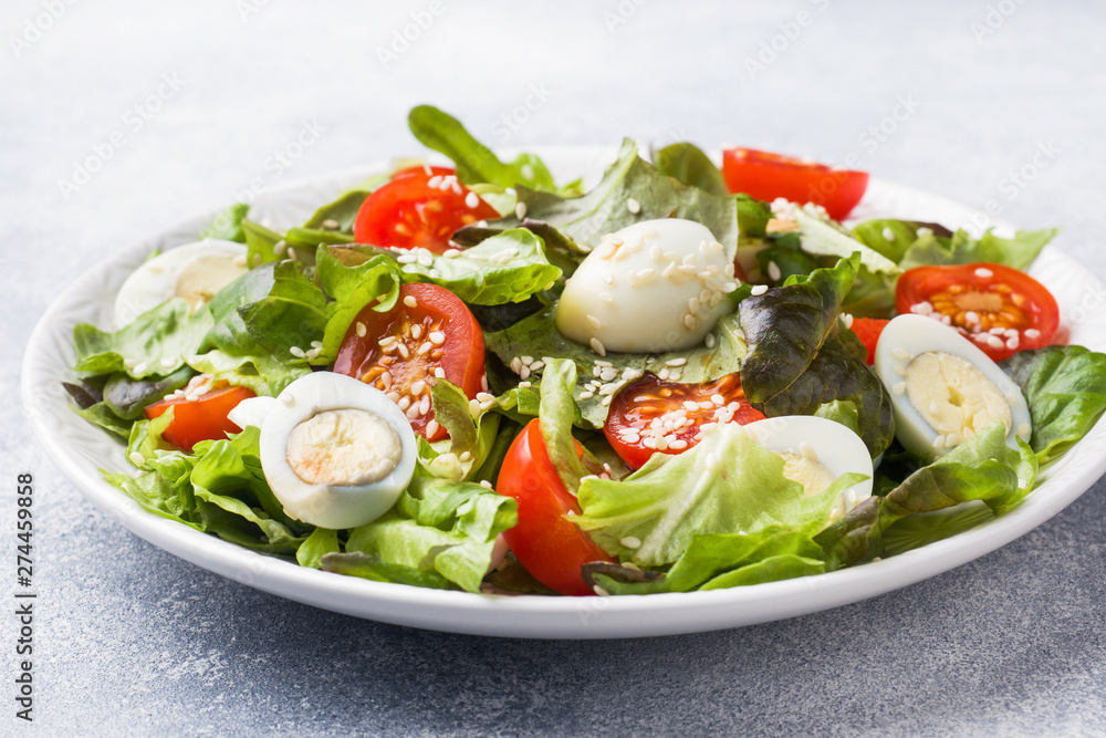 Fresh salad with tomatoes and quail eggs and lettuce. Fresh salad with tomatoes and quail eggs and lettuce.