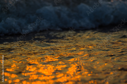 Amazing sea sunset on the pebble beach, the sun, waves, clouds