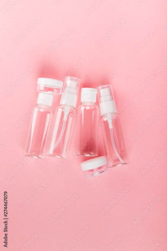 Travel small bottle set on a pink background. Top view Travel small bottle set on a pink background. Top view