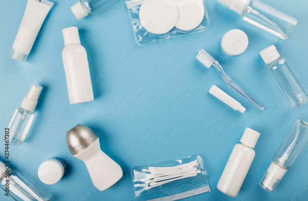 Travel small bottle set on blue background. Top view, copy space Travel small bottle set on blue background. Top view, copy space