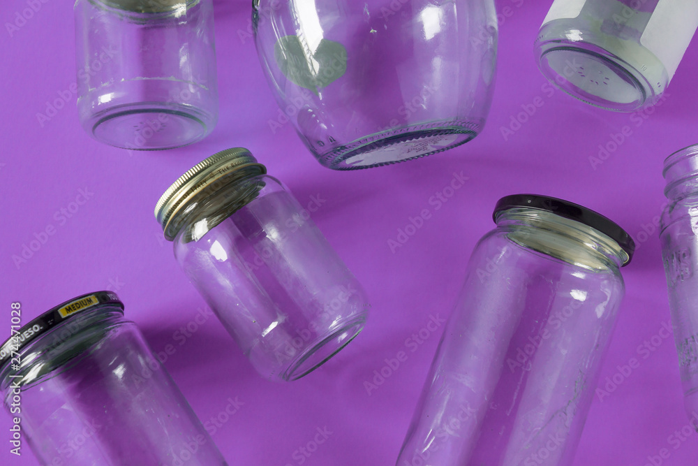 Glass jars with lids, purple background, top view flat lay recycling concept Glass jars with lids, purple background, top view flat lay recycling concept