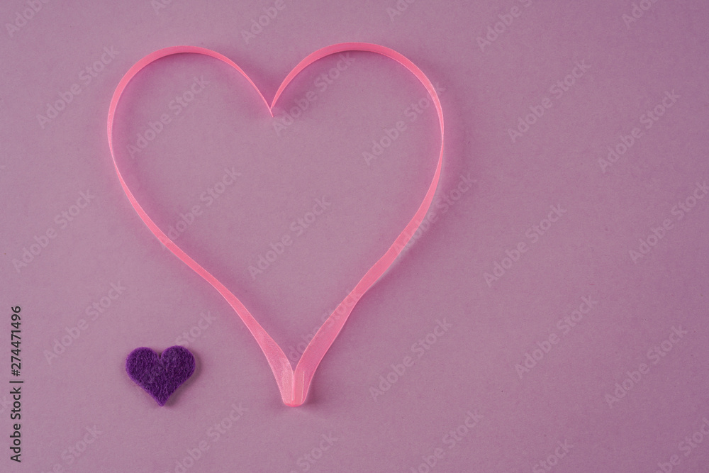 pink ribbon heart on purple background