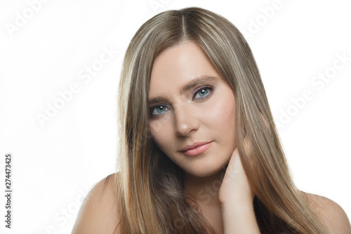 Stylish beautiful girl with flowing hair looking at camera with joyful happy facial expression.