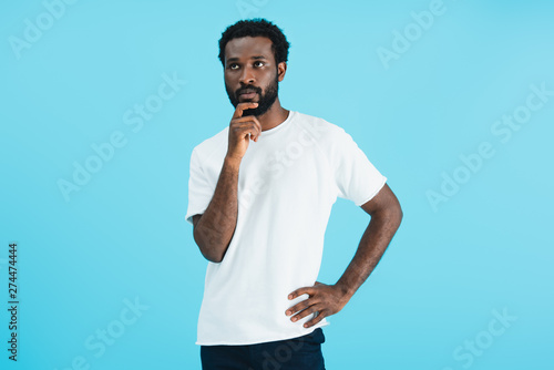 thoughtful african american man in white t-shirt isolated on blue