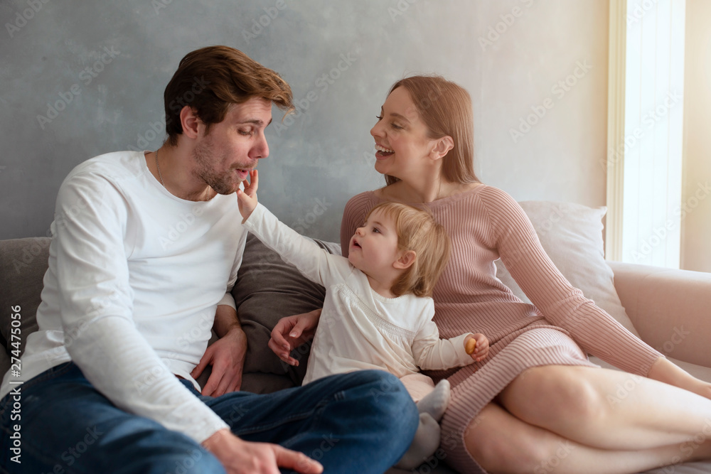 Happy little girl play with her mother and father Happy little girl play with her mother and father