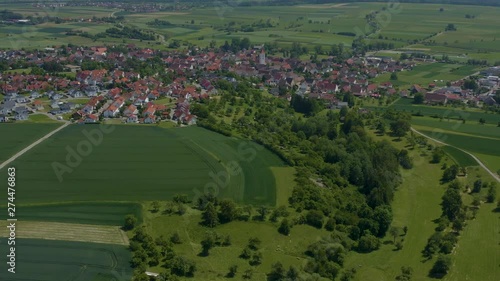  Aerial of Eutingen im Gäu, Germany.  Camera zooms in toward the town with fields in the foreground, high altitiude.   photo