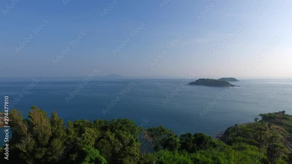 AERIAL 4K drone fly-through trees over Promthep Cape towards sea, Thailand AERIAL 4K drone fly-through trees over Promthep Cape towards sea, Thailand