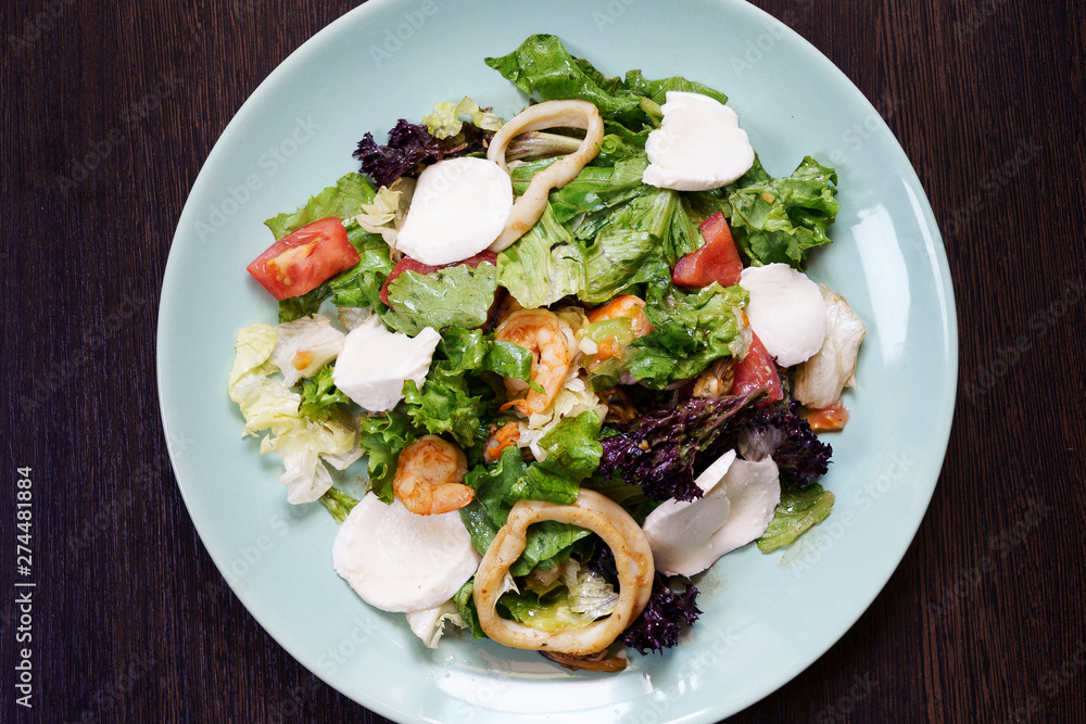 salad with shrimps, squids and vegetables, shot from above salad with shrimps, squids and vegetables, shot from above