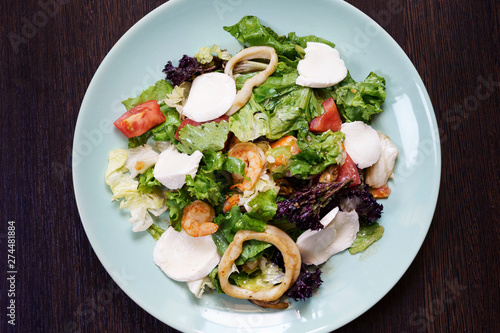 salad with shrimps, squids and vegetables, shot from above